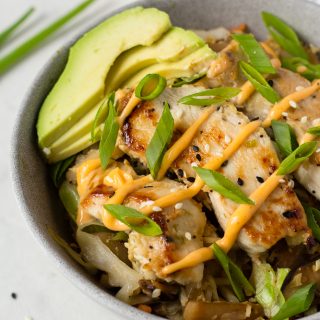 egg roll in a bowl with avocado on top