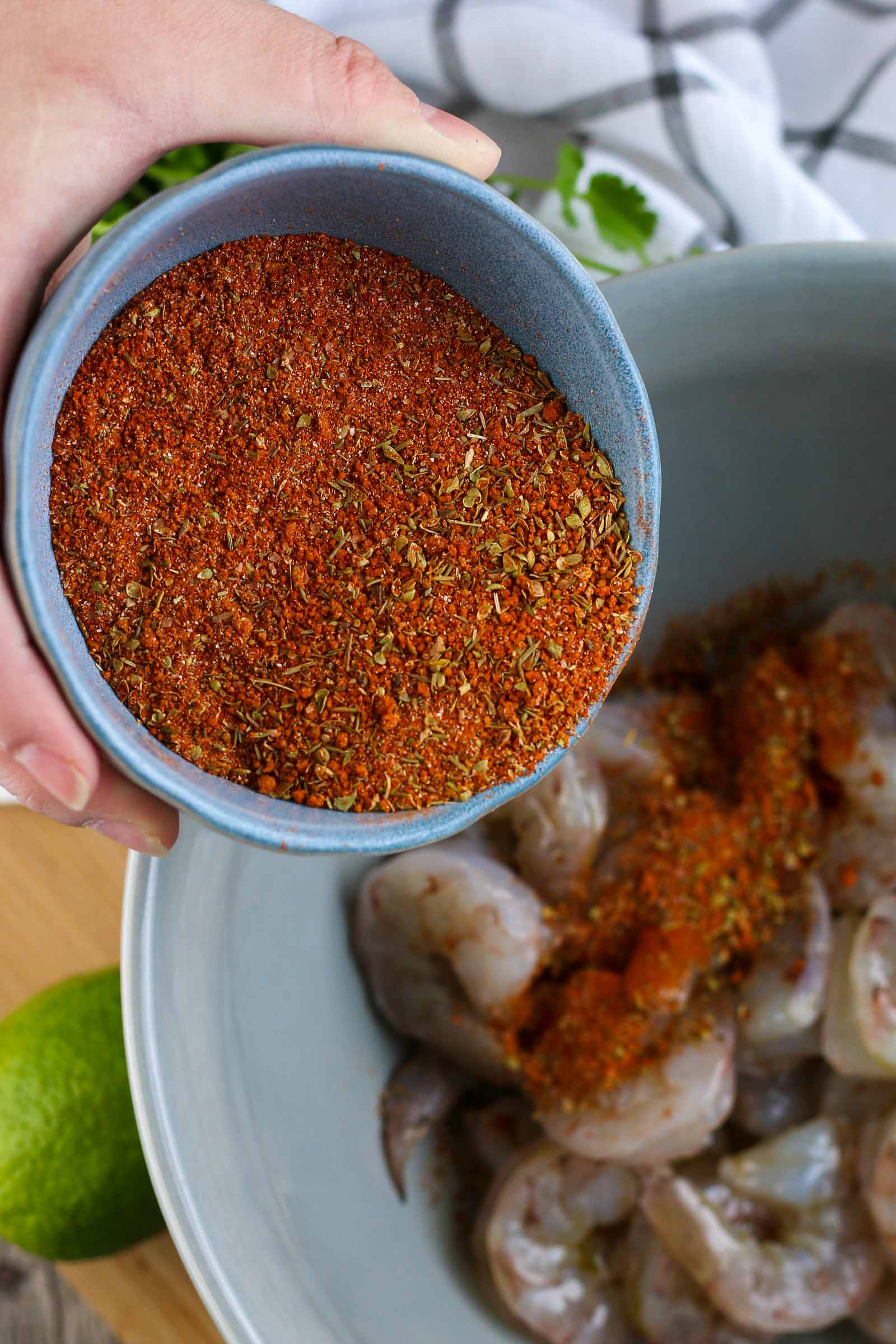 blackened seasoning going onto the shrimp