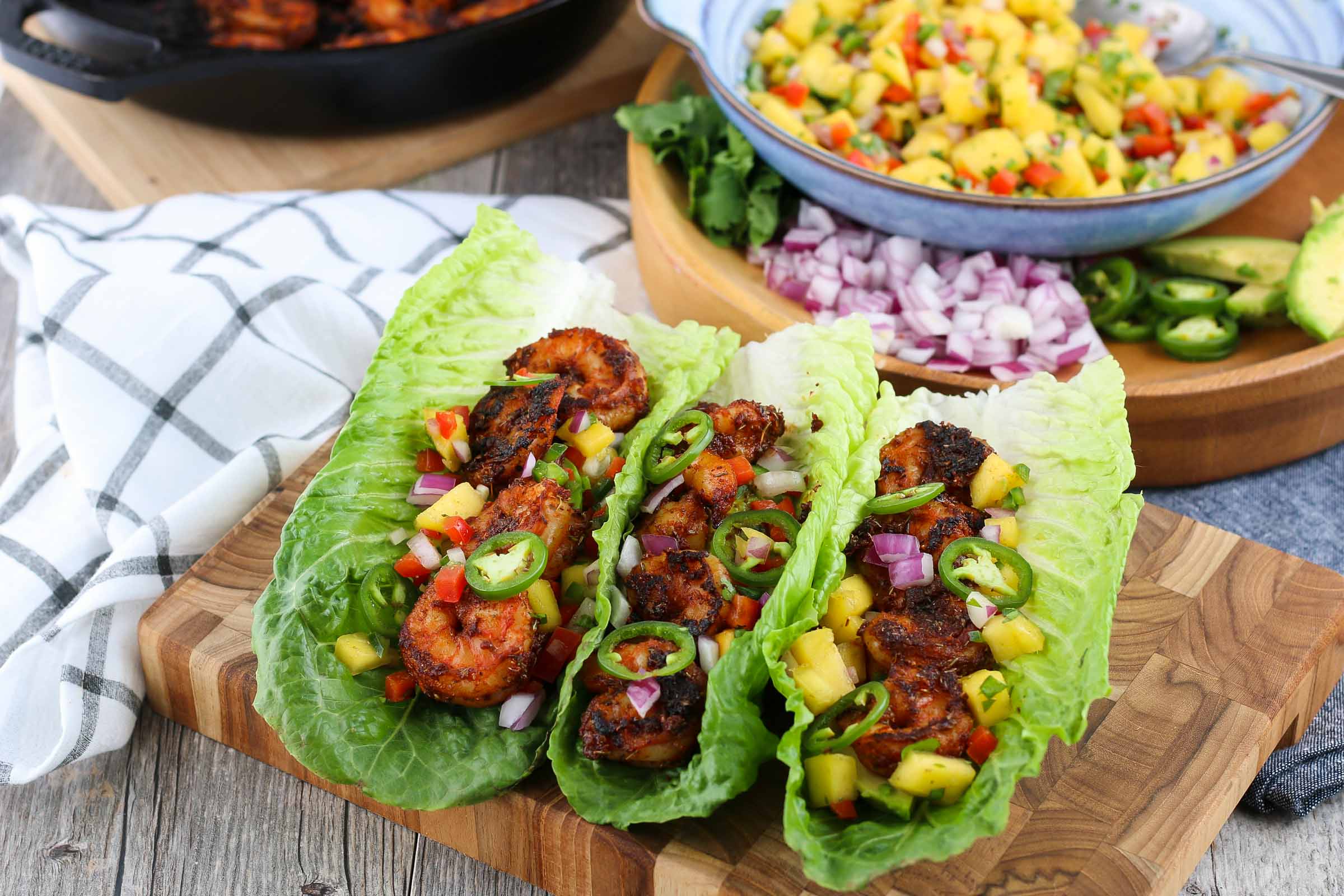 A close up shot of the finished blackened shrimp taco recipe in lettuce leaves ready to be eaten.