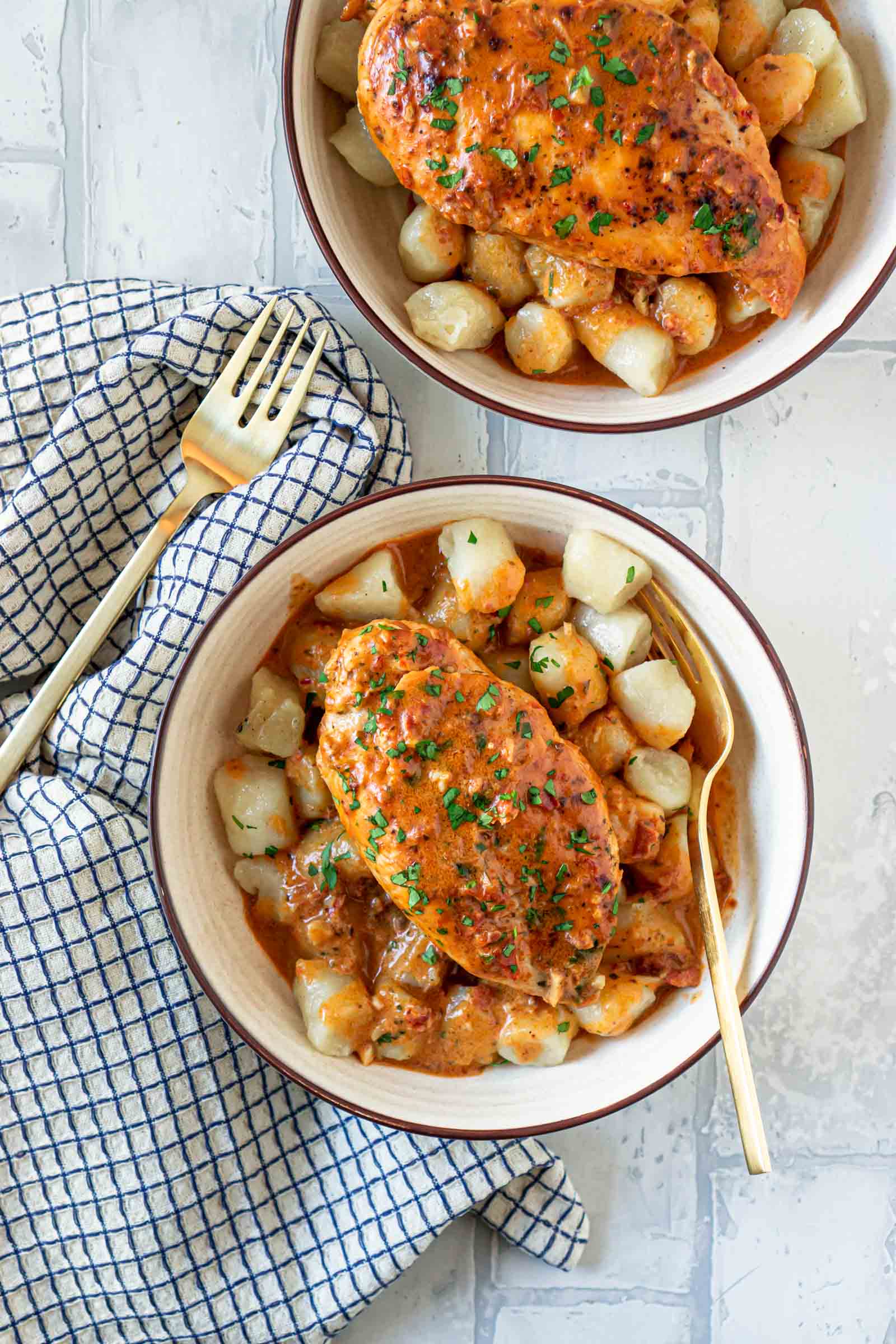 two bowls of cauliflower gnocchi with creamy sun dried tomato pesto chicken