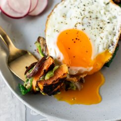a gold fork with a bite of sweet potato toast