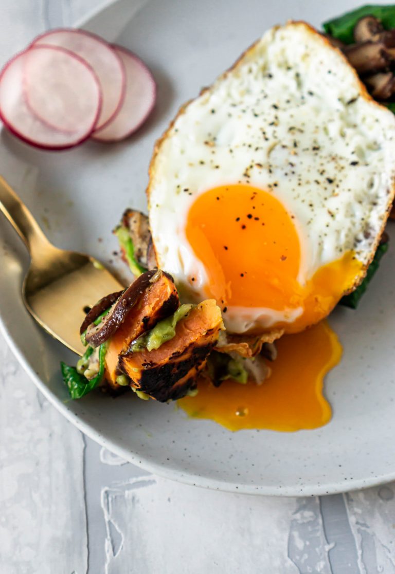 a gold fork with a bite of sweet potato toast