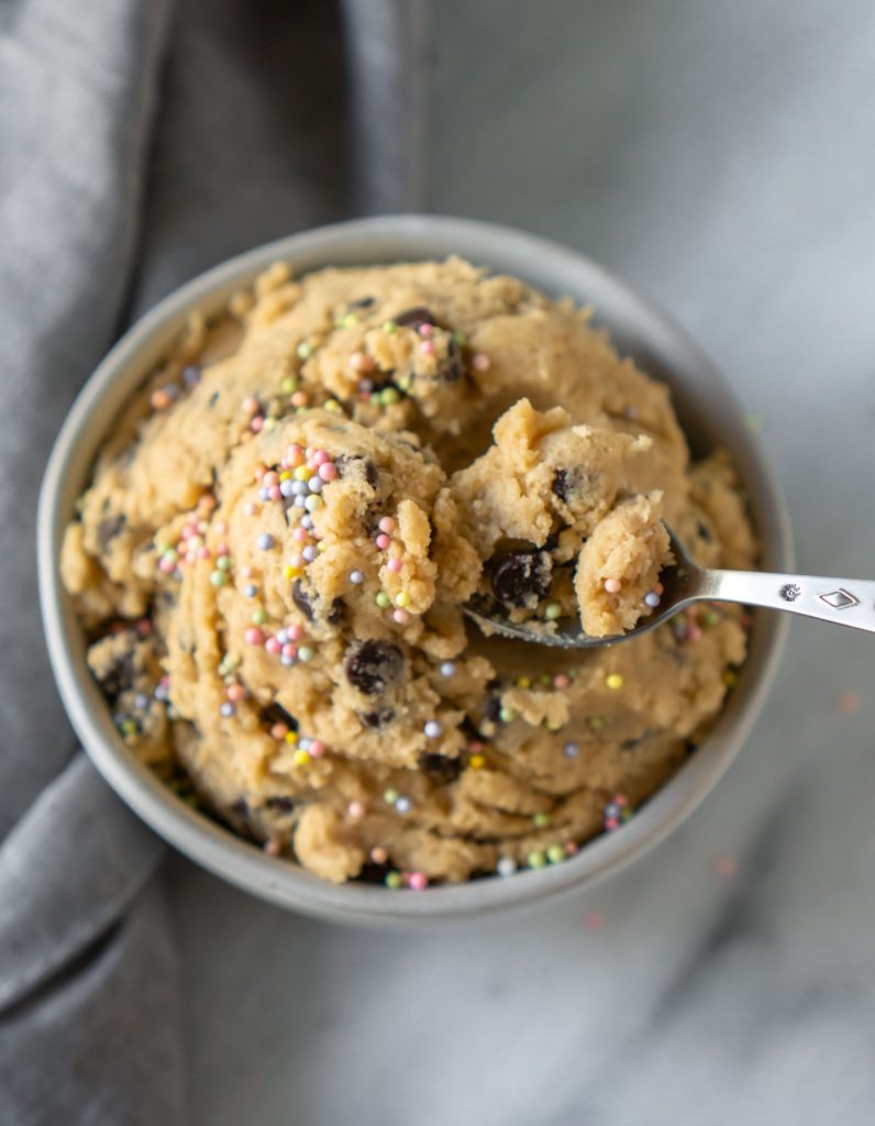 a spoon taking a bite out of the cookie dough