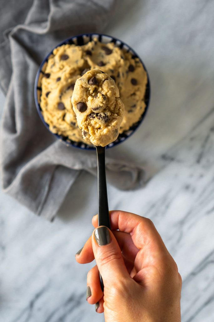 chocolate chip cookie dough on a black spoon