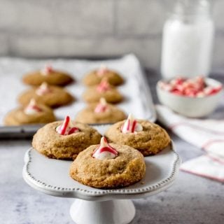 3 candy cane hershey kiss cookies on a cake stand