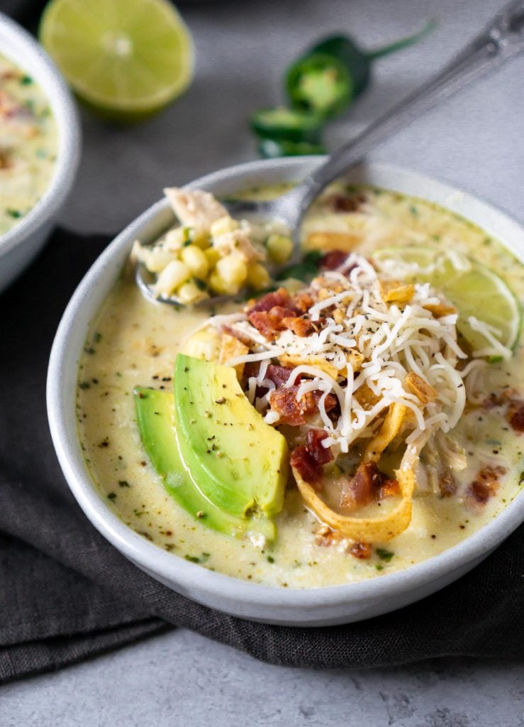 mexican street corn white chicken chili in a bowl with a silver spoon
