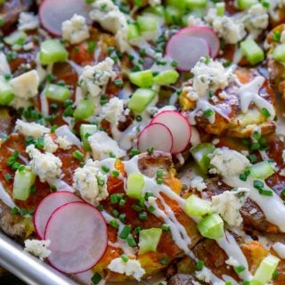 close up photo of crispy smashed potatoes loaded nachos