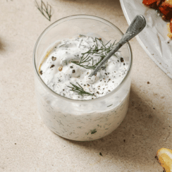 lemon dill sauce for salmon patties in a glass jar with a spoon