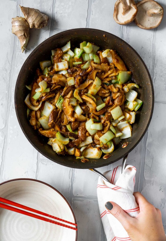 miso butter mushrooms and bok choy in a pan