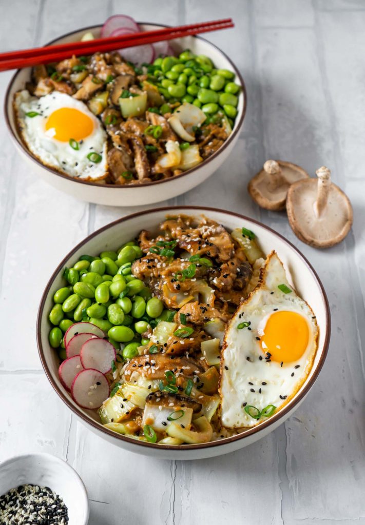 two miso mushroom bowls and a bowl of sesame seeds