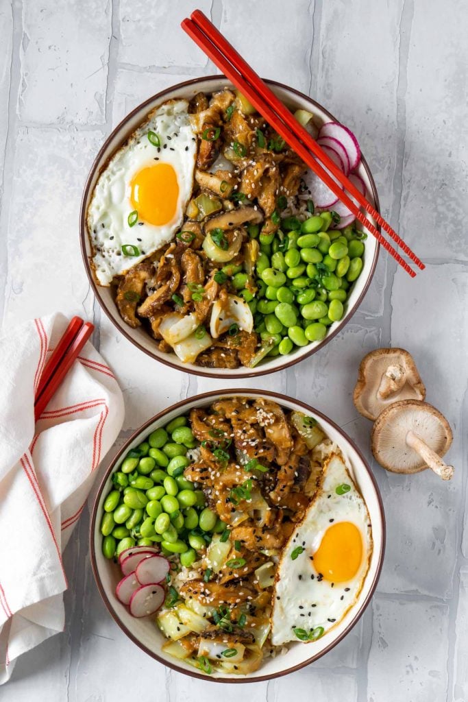 two maple miso mushroom bowls with two pairs of red chopsticks