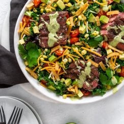 tex mex flank steak salad in a large white bowl