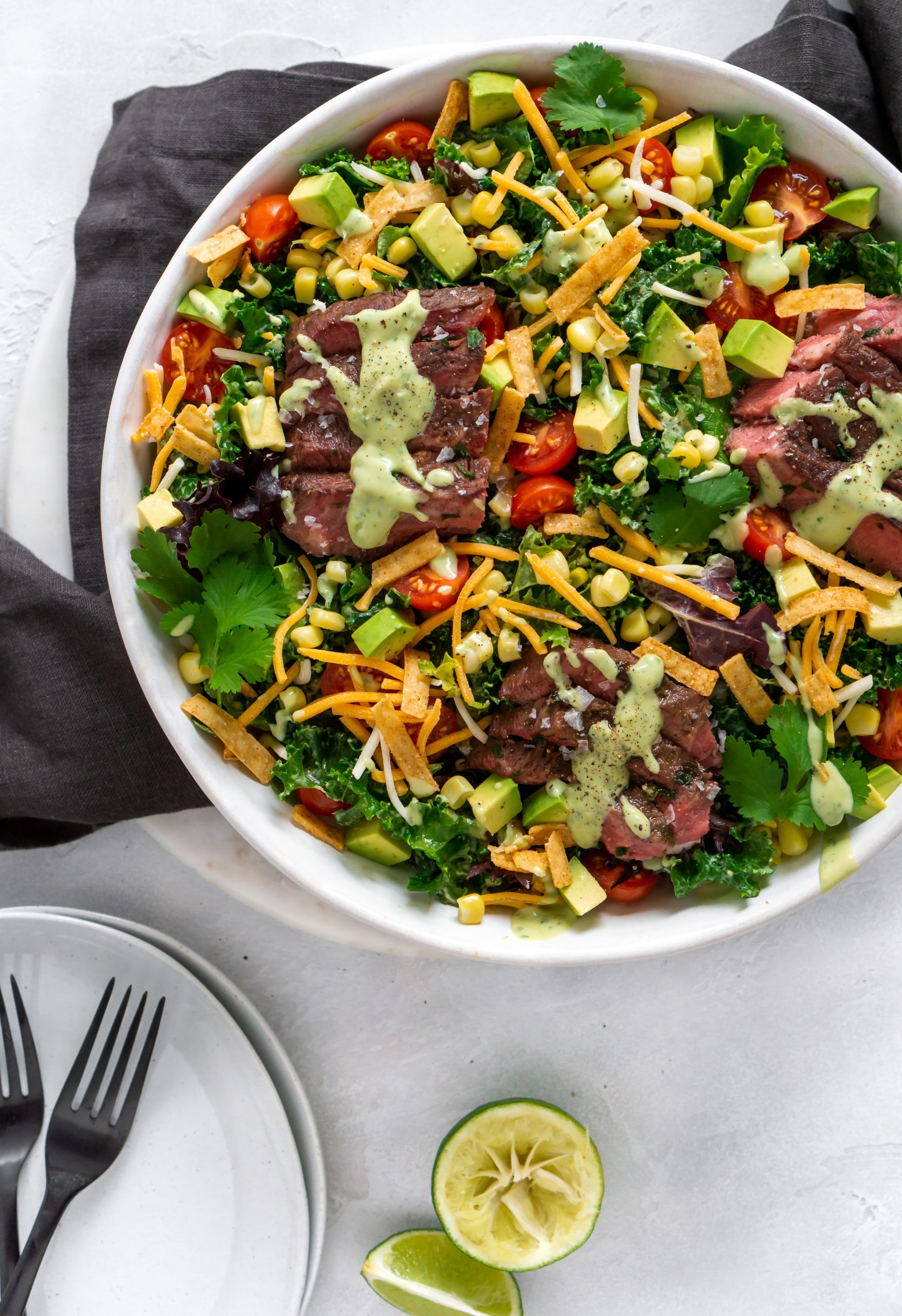 tex mex flank steak salad in a large white bowl