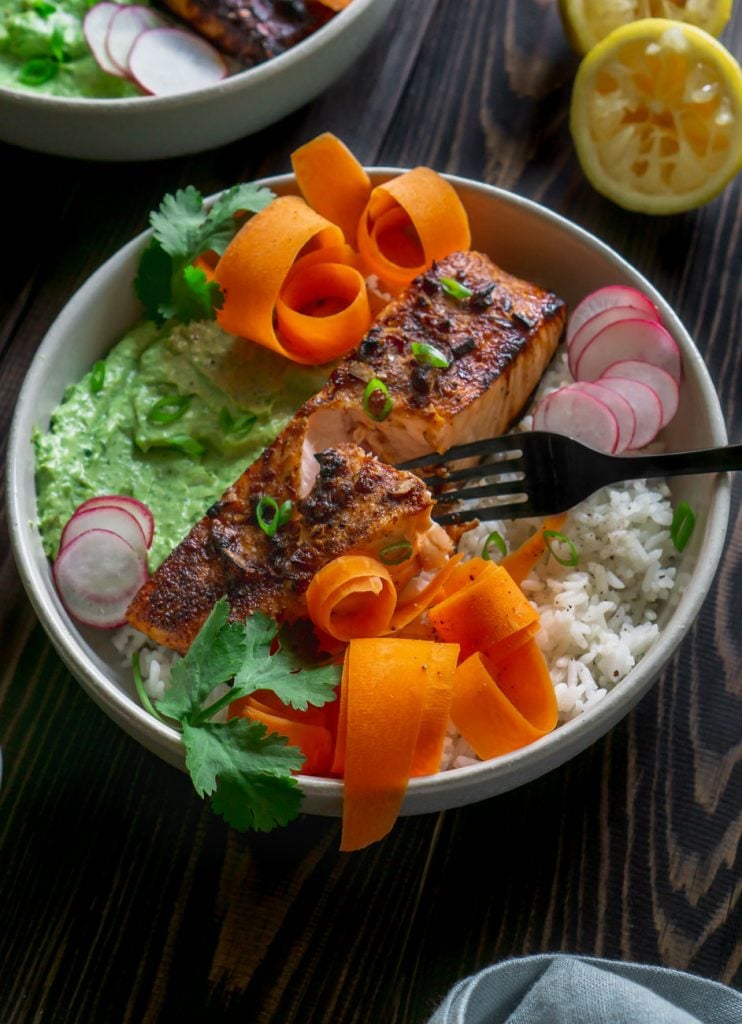 a black fork in the blackened salmon bowl