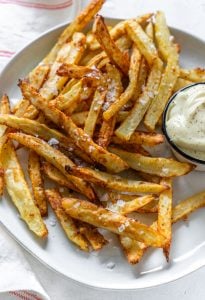 garlic parmesan fries on a plate with mayo