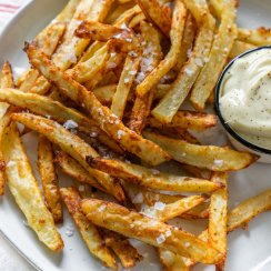 garlic parmesan fries on a plate with mayo