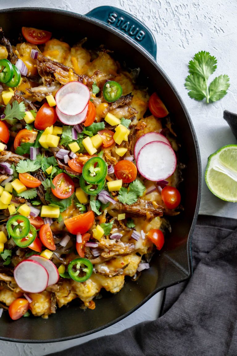 slow cooker carnitas tater tot nachos in a skillet