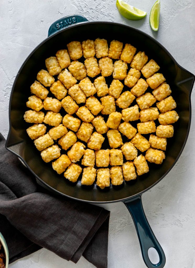 tater tots in a cast iron skillet