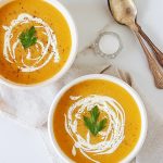 vegan red lentil soup in two white bowls