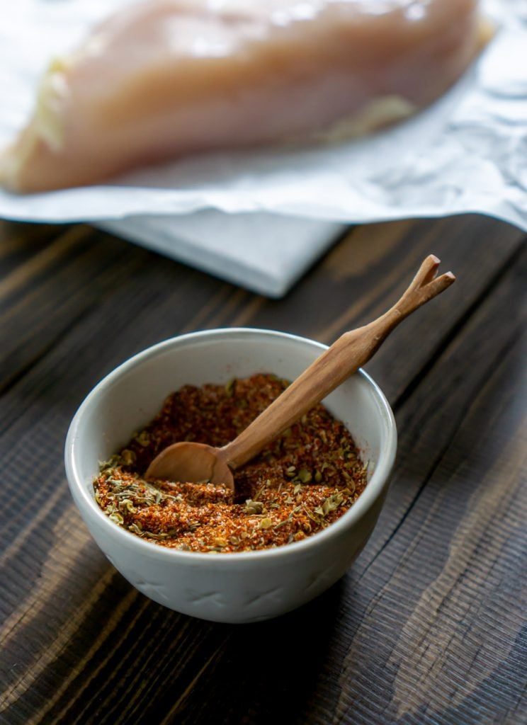 spice mixture in a small bowl with a wooden spoon