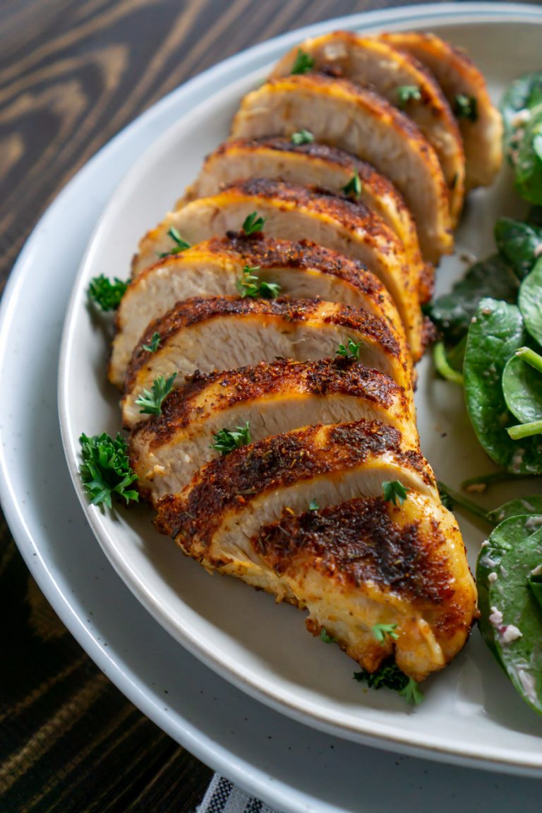 air fryer chicken sliced and on a white plate