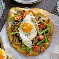 vegetable breakfast pizza on parchment paper