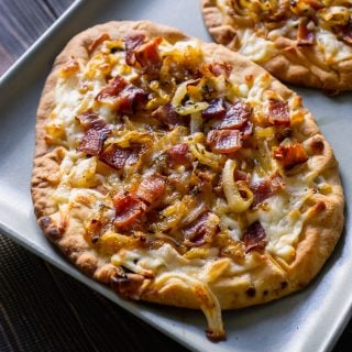 bacon pizza on a blue serving tray