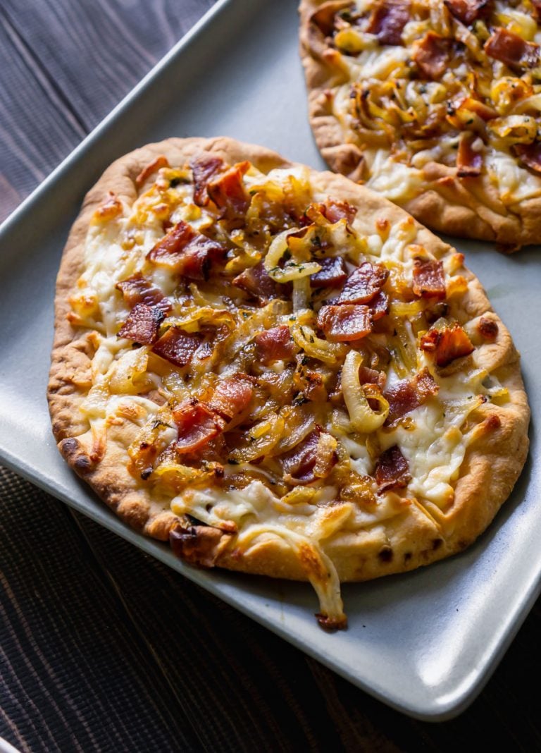 bacon pizza on a blue serving tray