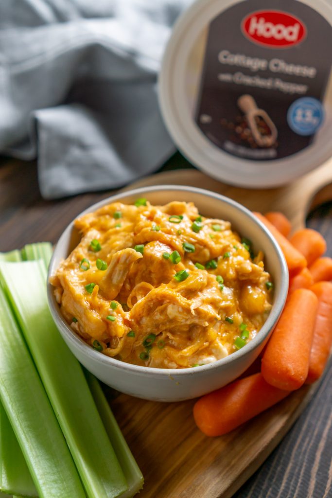 skinny buffalo chicken dip in a small bowl with carrots and celery