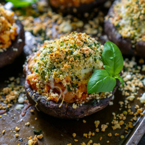 air fryer chicken parmesan stuffed mushrooms on a baking sheet with basil