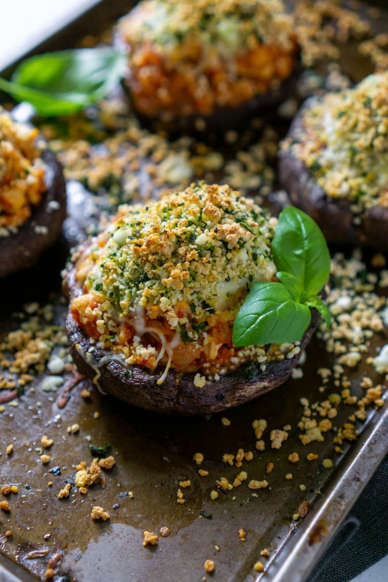 air fryer chicken parmesan stuffed mushrooms on a baking sheet with basil