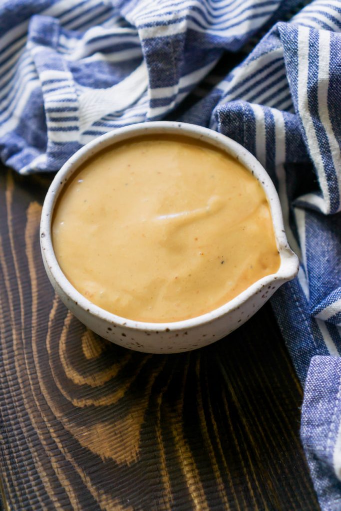 chik fil a sauce in a small bowl and a blue striped napkin