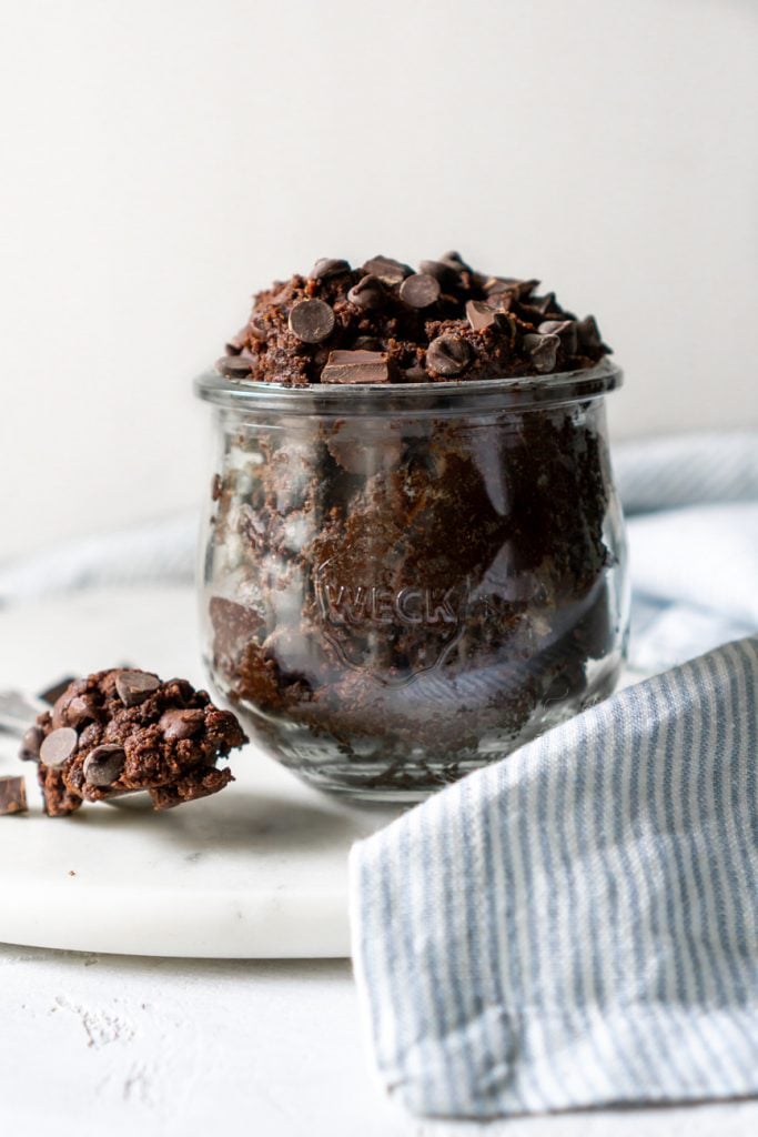 edible brownie batter in a glass weck jar and on a spoon