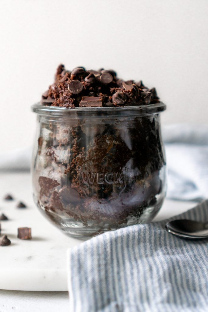edible brownie batter in a glass weck jar with a blue striped napkin