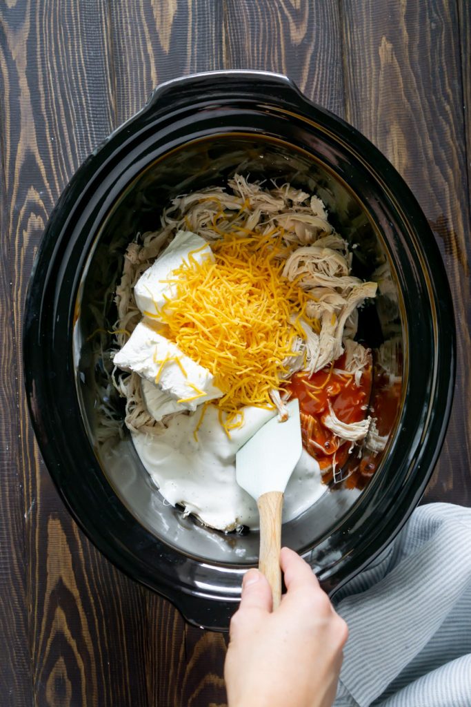 mixing buffalo chicken ingredients in the slow cooker