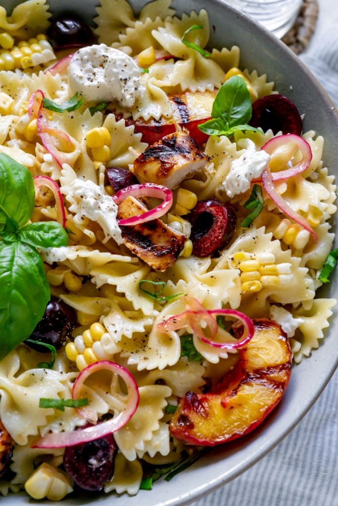 grilled chicken pasta salad in a large bowl close up