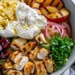 burrata corn, grilled peaches, basil, and chicken in a large bowl