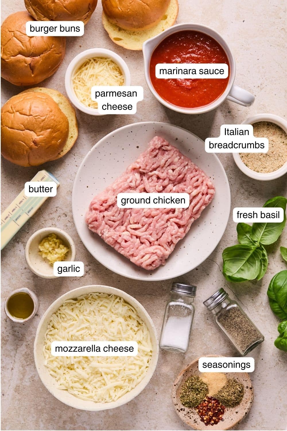 Every ingredient needed for chicken parm burgers portioned out in bowls.