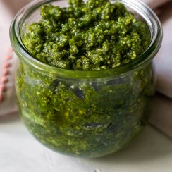 basil mint pesto in a glass jar with a pink napkin