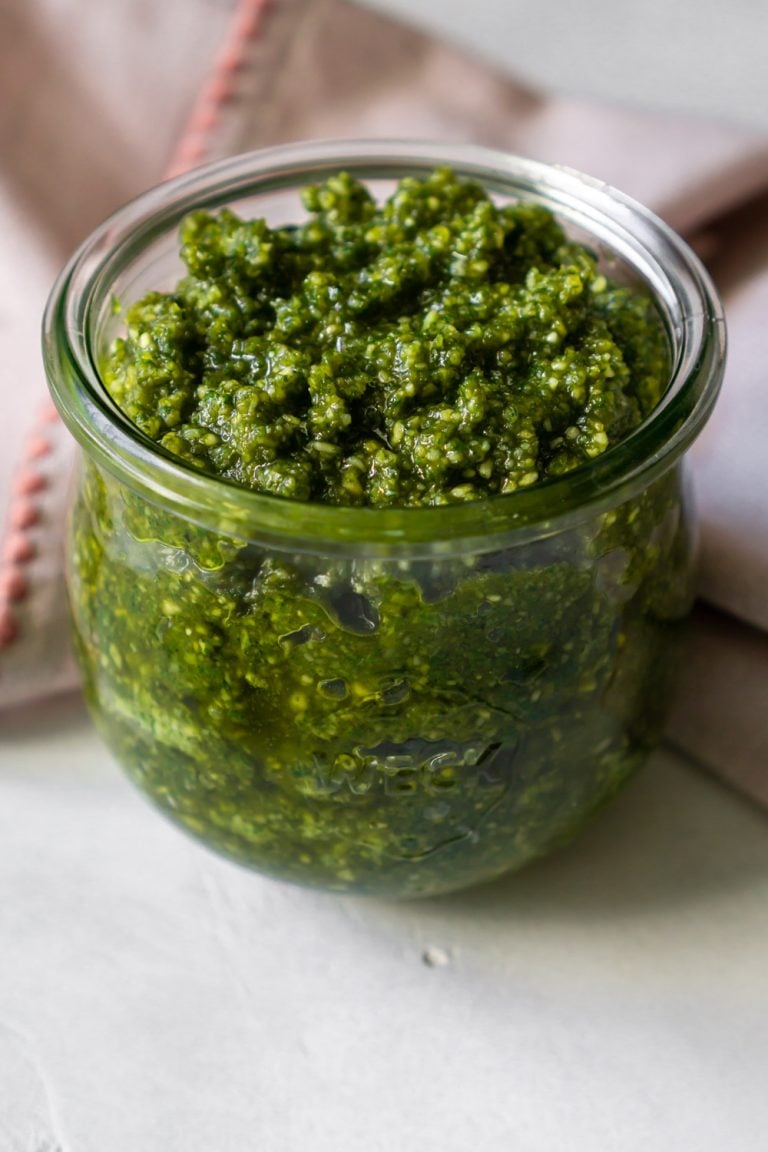 basil mint pesto in a glass jar with a pink napkin