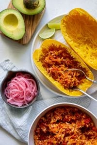 two forks with taco filling in spaghetti squash