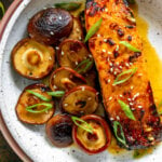 asian salmon with mushrooms in a white bowl