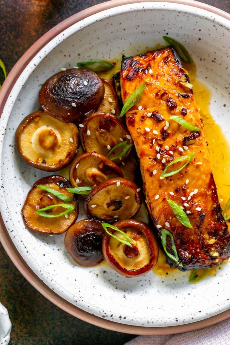 asian salmon with mushrooms in a white bowl