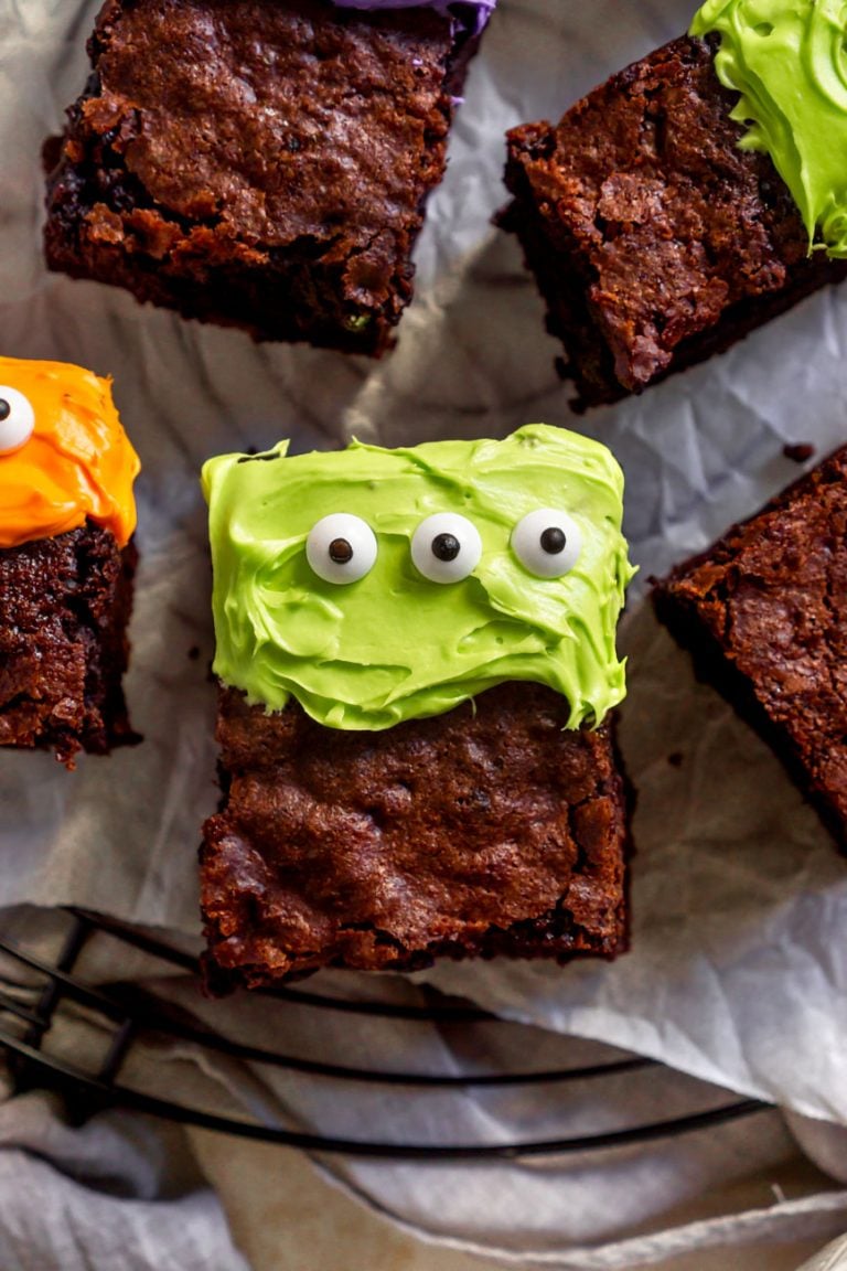 cake brownie with green frosting on a cooling rack