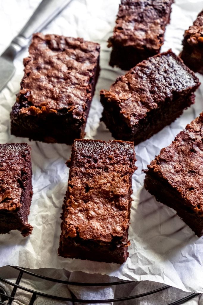 cake brownies on a black cooling rack with parchment paper