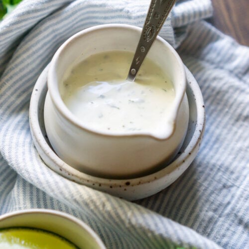 cilantro lime crema in a saucer with a silver spoon