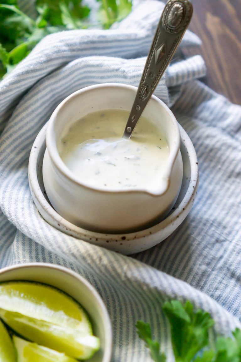 cilantro lime crema in a saucer with a silver spoon