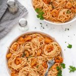 shrimp scampi in two white bowls