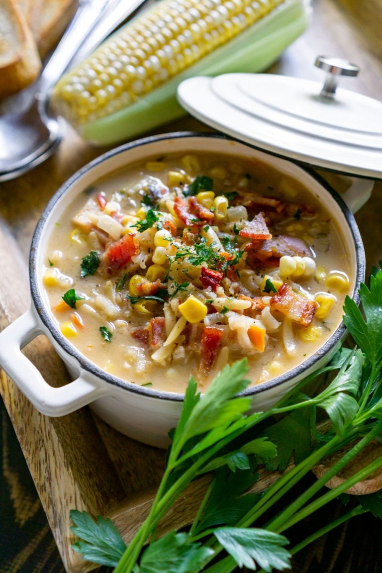 corn chowder in a white bowl with parsley.