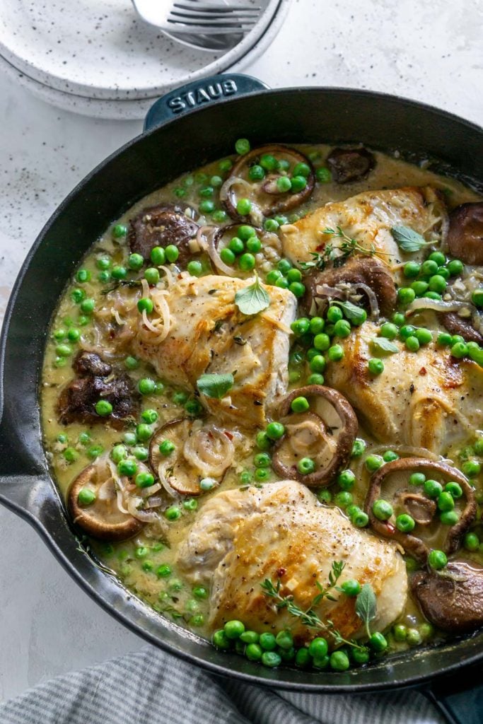 chicken, peas, and mushrooms in a skillet